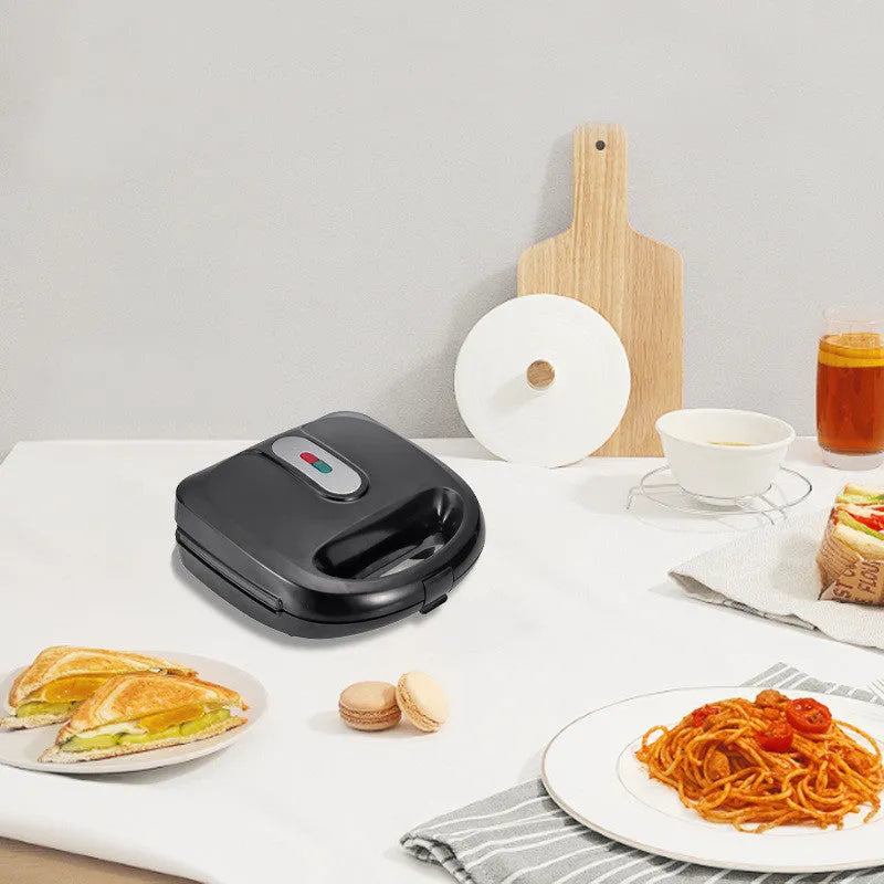 Black double-sided electric sandwich pan with six interchangeable non-stick plates and brushed stainless steel cover
