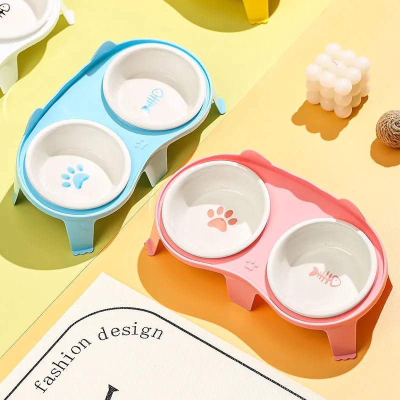 Blue ceramic tilted cat food and water bowls on a white ABS stand with a hook for a water bottle.