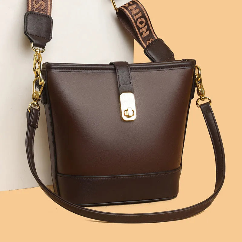 Black PU leather bucket bag with double shoulder straps showing internal compartments and external pocket