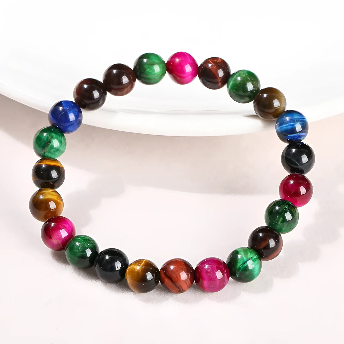 Colourful Tiger Eye stone bracelet with round beads on a mixed string, showing available sizes.