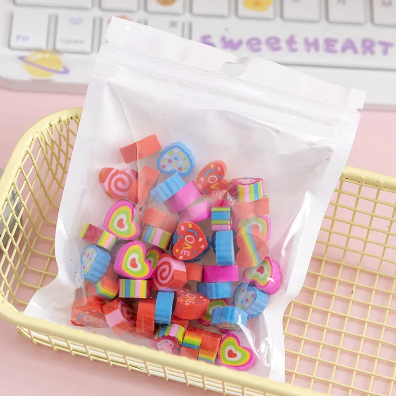 Assortment of 50 colourful miniature cartoon erasers including fruit, animal and theme designs.