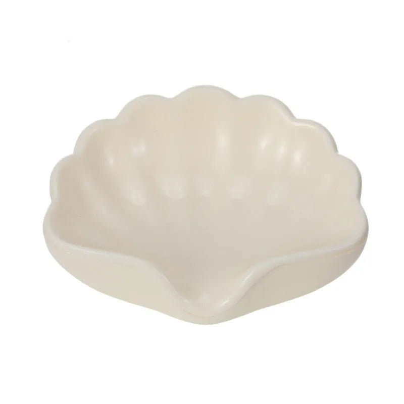 White shell-shaped plastic soap dish for bathroom counter