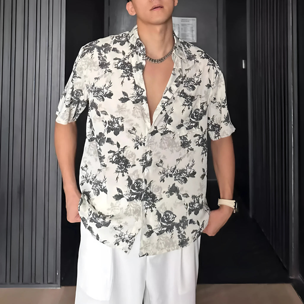 Man's loose-fit short sleeve shirt with printed floral pattern and pendant detail in black