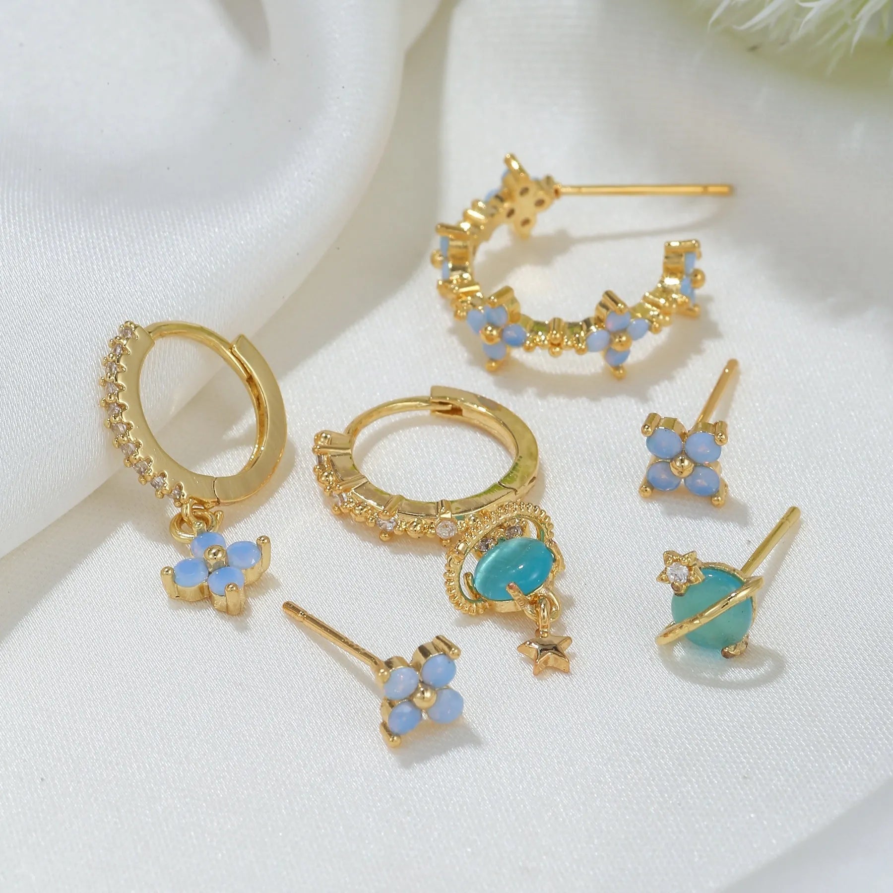 Flower-shaped ear studs with protein nail and zircon mosaic details in gold or silver Japanese Korean style