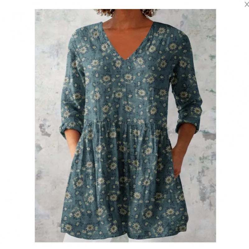 Women's loose-fit dress with a blue and white wave print, wide waist, and 3/4 length sleeves.