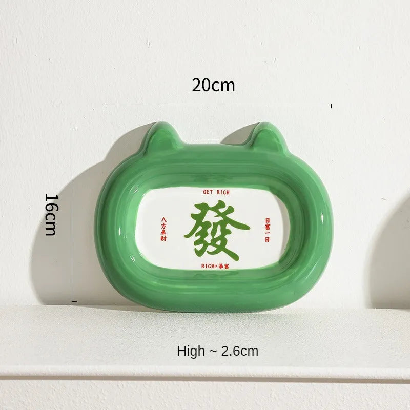 Ceramic pet bowl with animal motif design and raised base for cat or small dog feeding