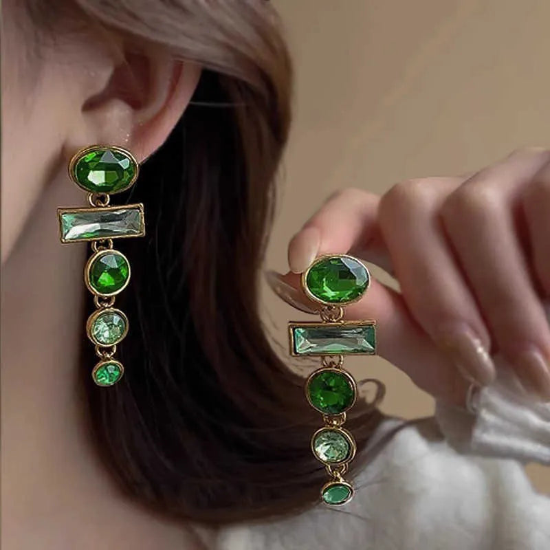 Green gradient geometric drop earrings with zircon inlays and a tassel design.