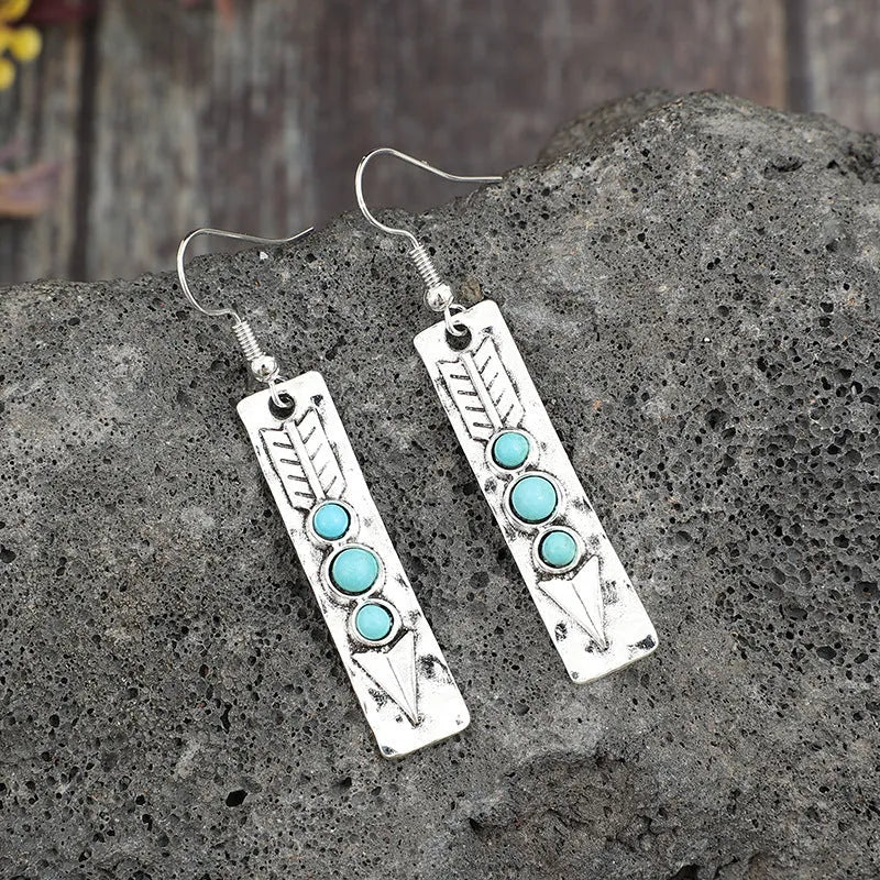 Silver-coloured geometric earrings with turquoise inlay measuring 20-24cm long