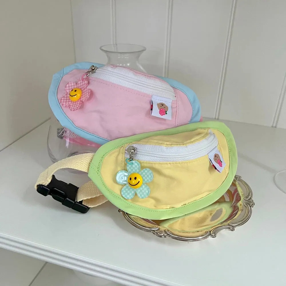 Powder blue messenger-style dog backpack for cats on a person's back, showing adjustable strap and poop bag holder.