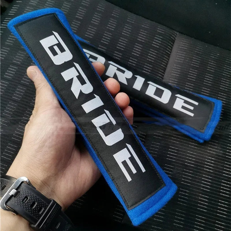 Car seatbelt shoulder pads with embroidery detail in black, blue, and red colour options