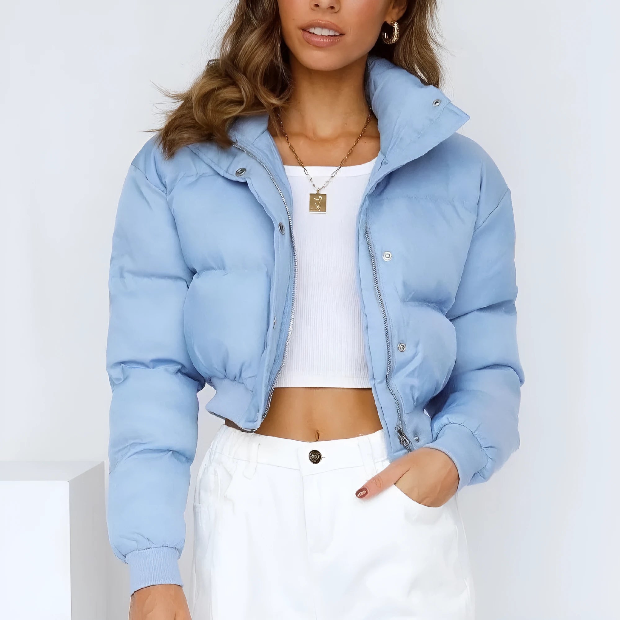 Women's loose blue polyester jacket with long sleeves on a hanger.