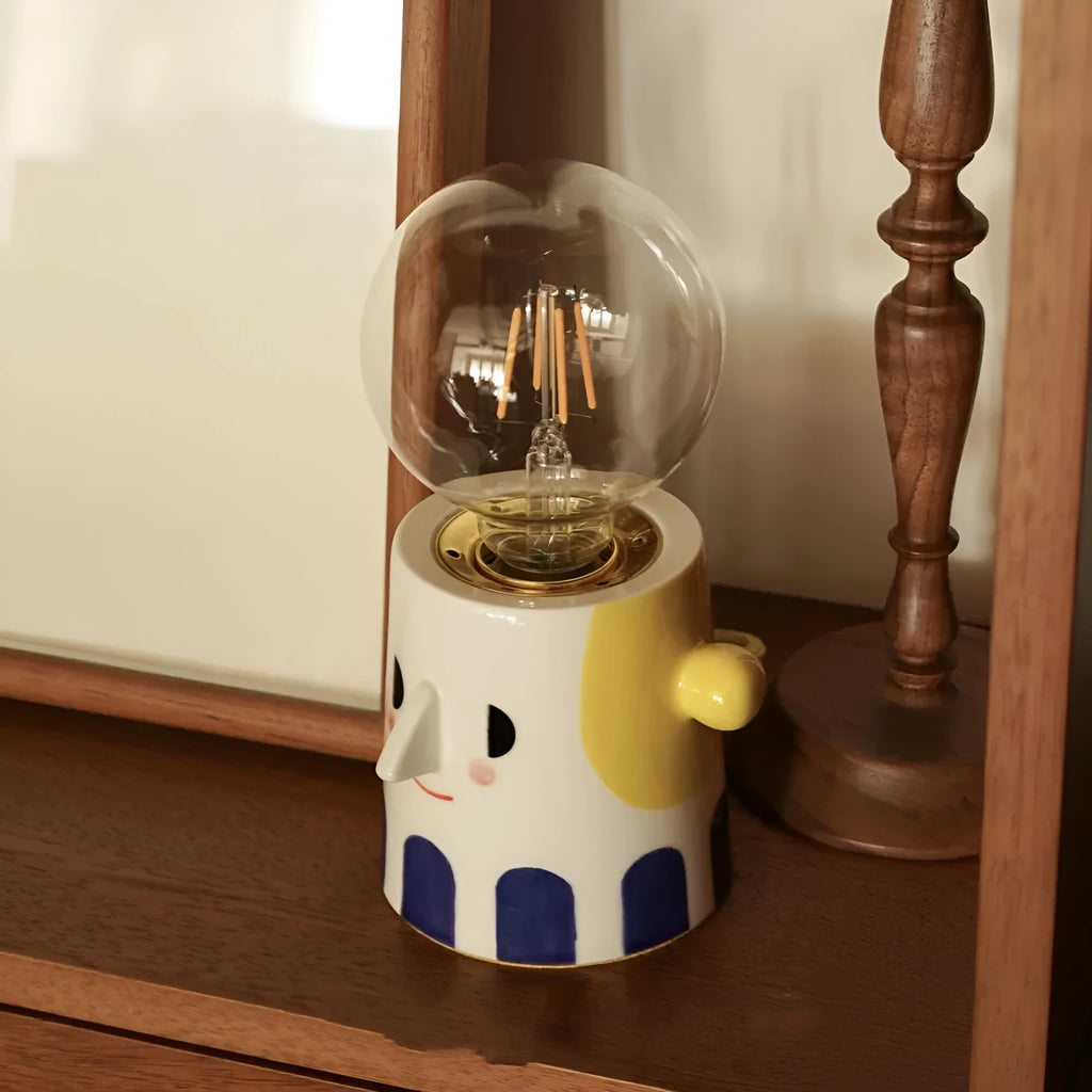 Handmade ceramic bedside lamp with spherical shade on wooden table
