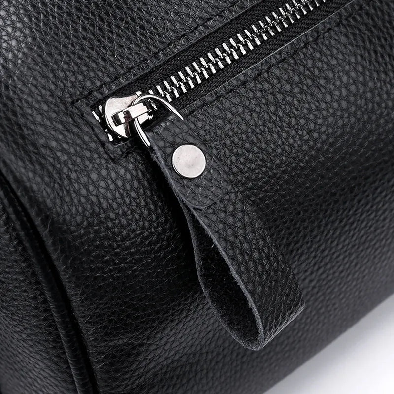 Black genuine leather one-shoulder crossbody bag showing its large size and polyester lining.