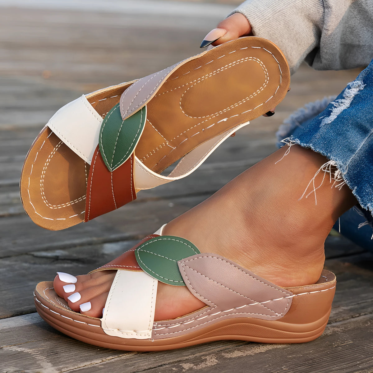 Black women's peep-toe slippers with a cross-strap design and a thick sole.