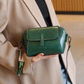 Women's brown oil wax cowhide leather shell shape messenger bag with cross-body strap and interior compartments