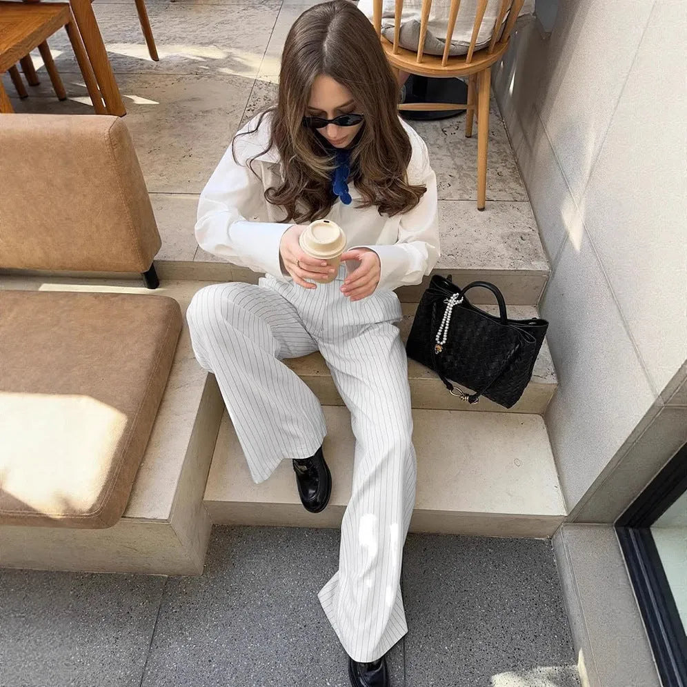 White striped wide-leg loose fit trousers with zipper front on a hanger