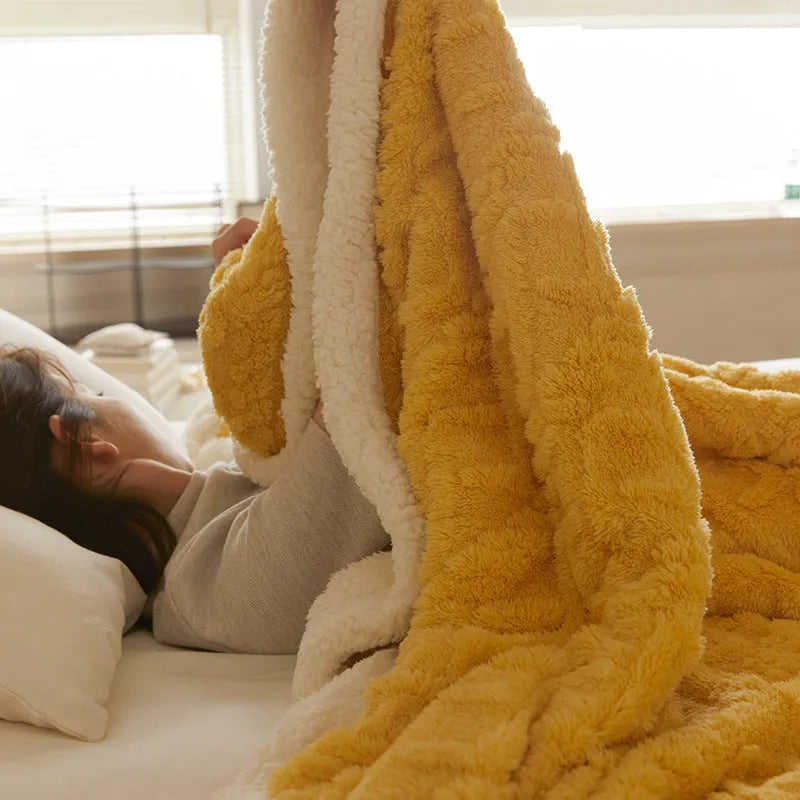 Polyester thermal flannel blanket in beige colour showing modern simple style on a bed.