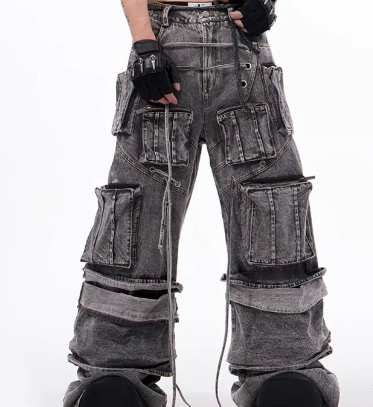 Grey distressed denim overalls with rope stitching and mop pant design on male model
