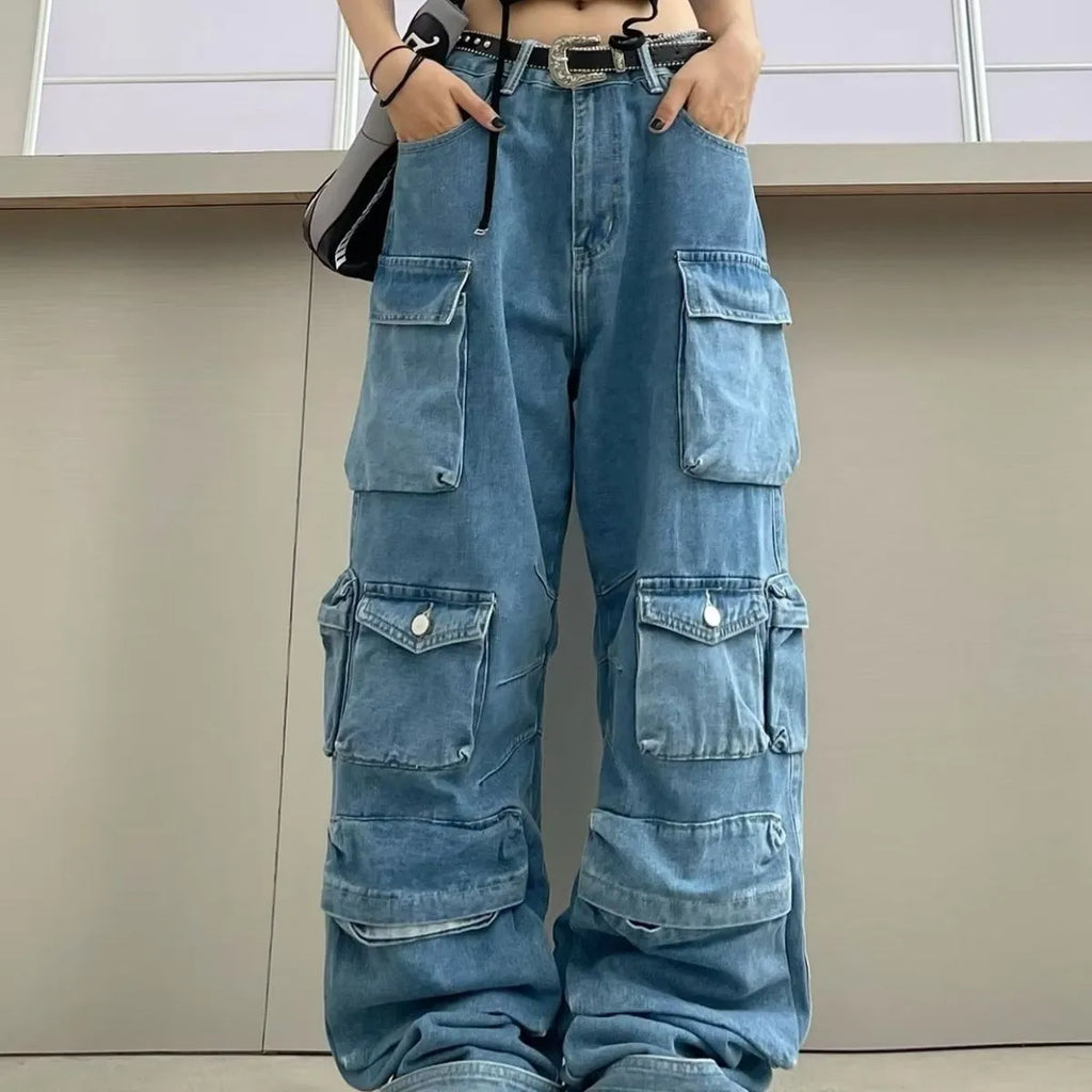 Women's blue high waist wide leg denim jeans with multiple pockets on a neutral background.