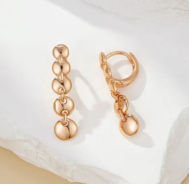 Retro long round copper earrings with woven design in a gold colour finish.