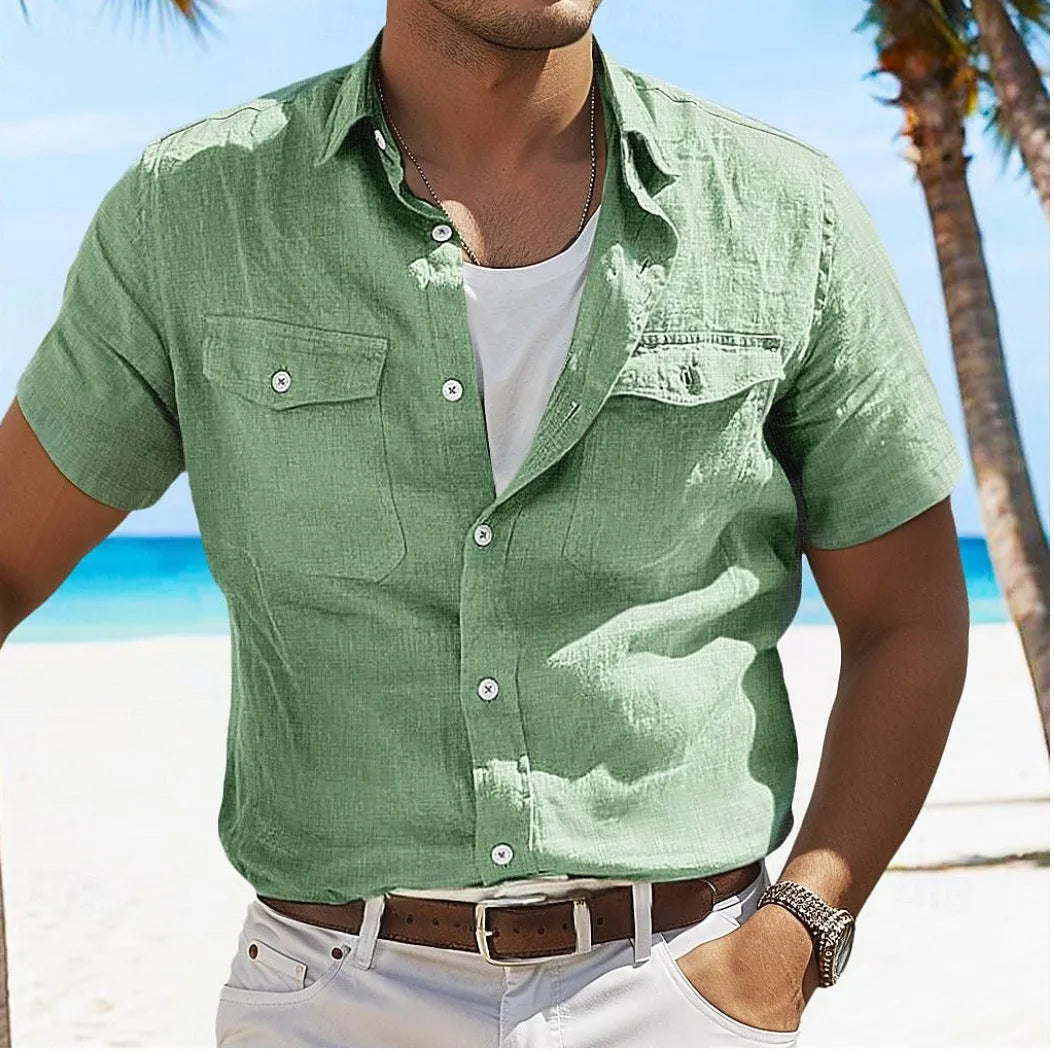 Man wearing a loose grey cotton cardigan-style shirt with long sleeves.