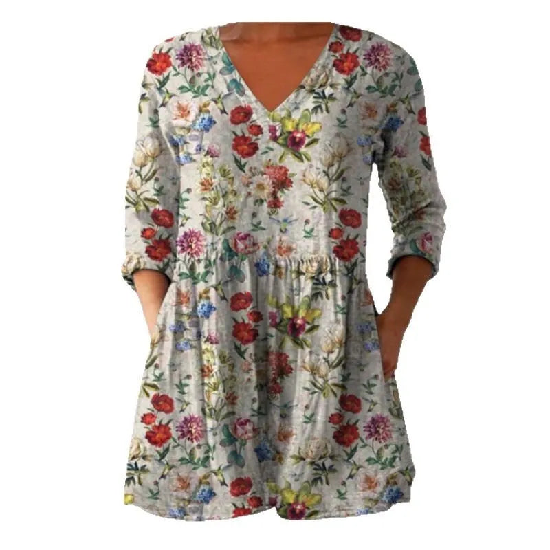 Women's loose-fit dress with a blue and white wave print, wide waist, and 3/4 length sleeves.