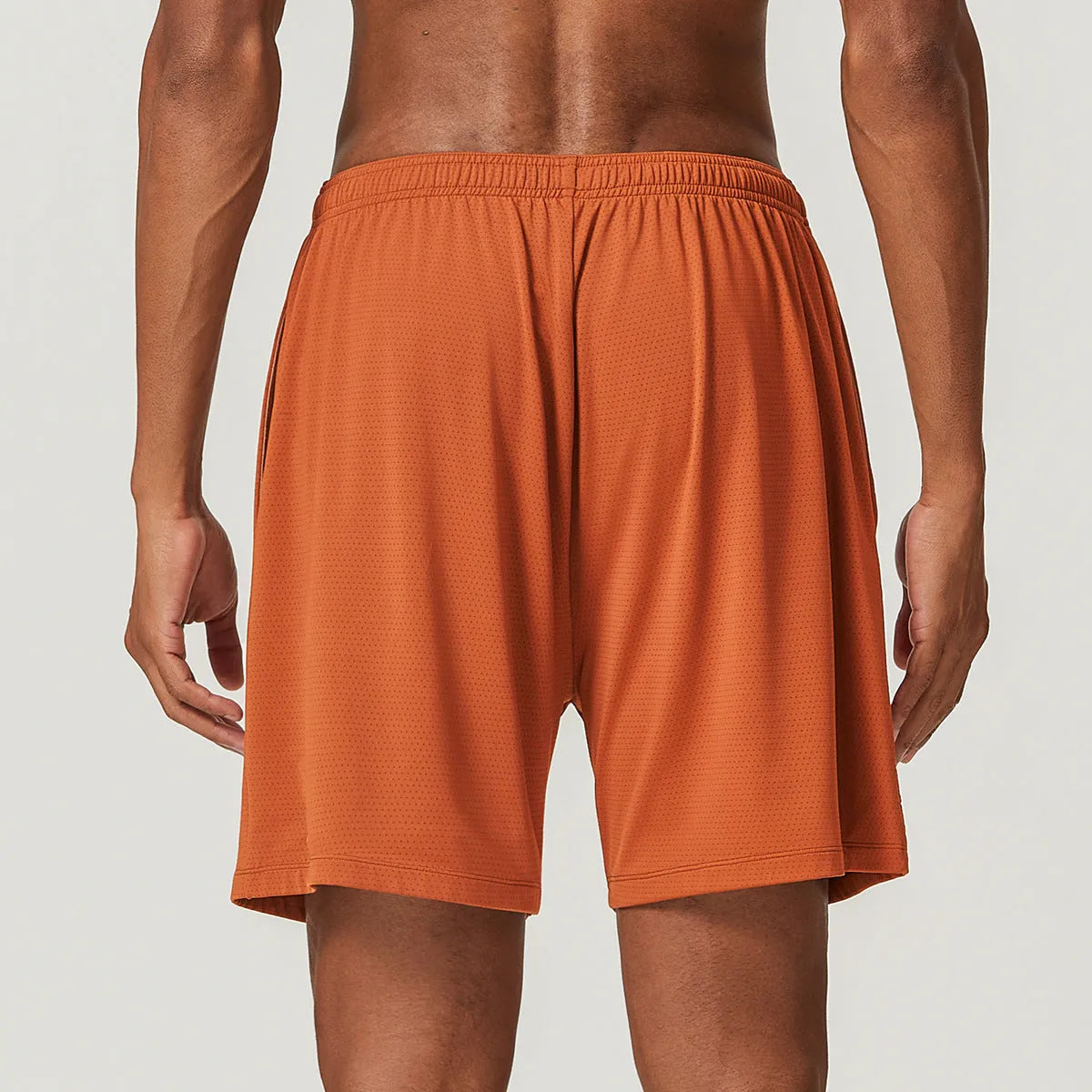 Men's quick-drying double-layer running shorts in khaki colour, showing mid-waist fit and shorts length.