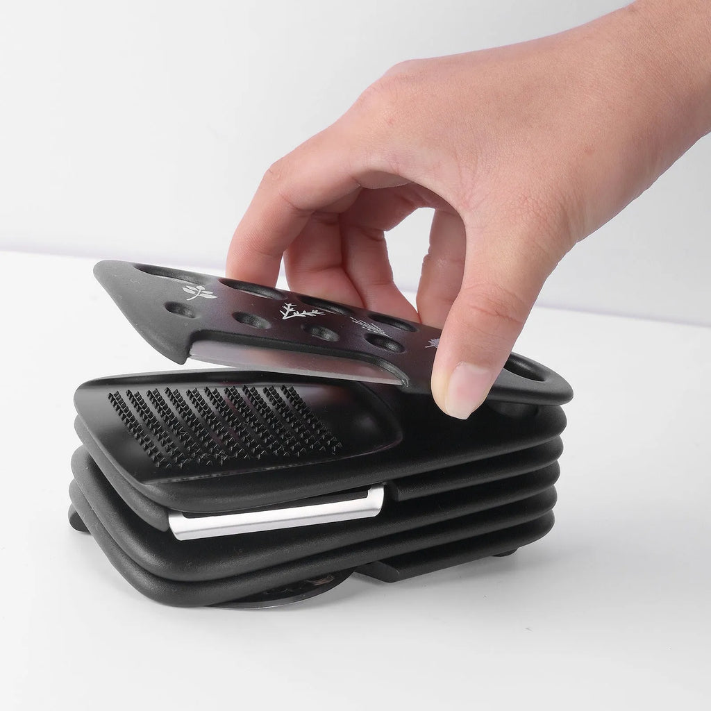 Six kitchen gadgets with brush in stacking configuration showing stainless steel and plastic components