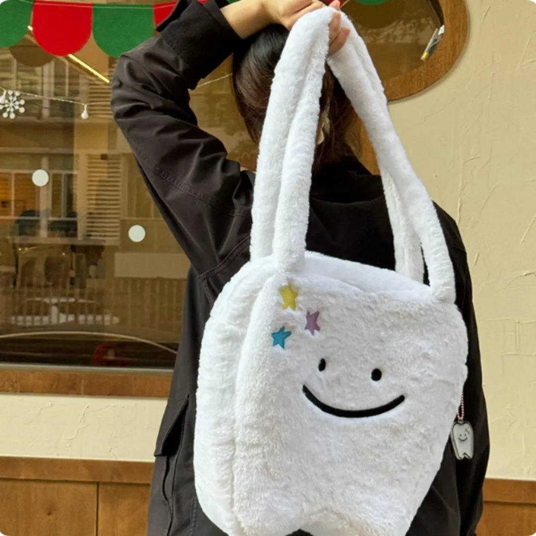 White plush large tooth shoulder tote bag with zip opening shown as crossbody carry