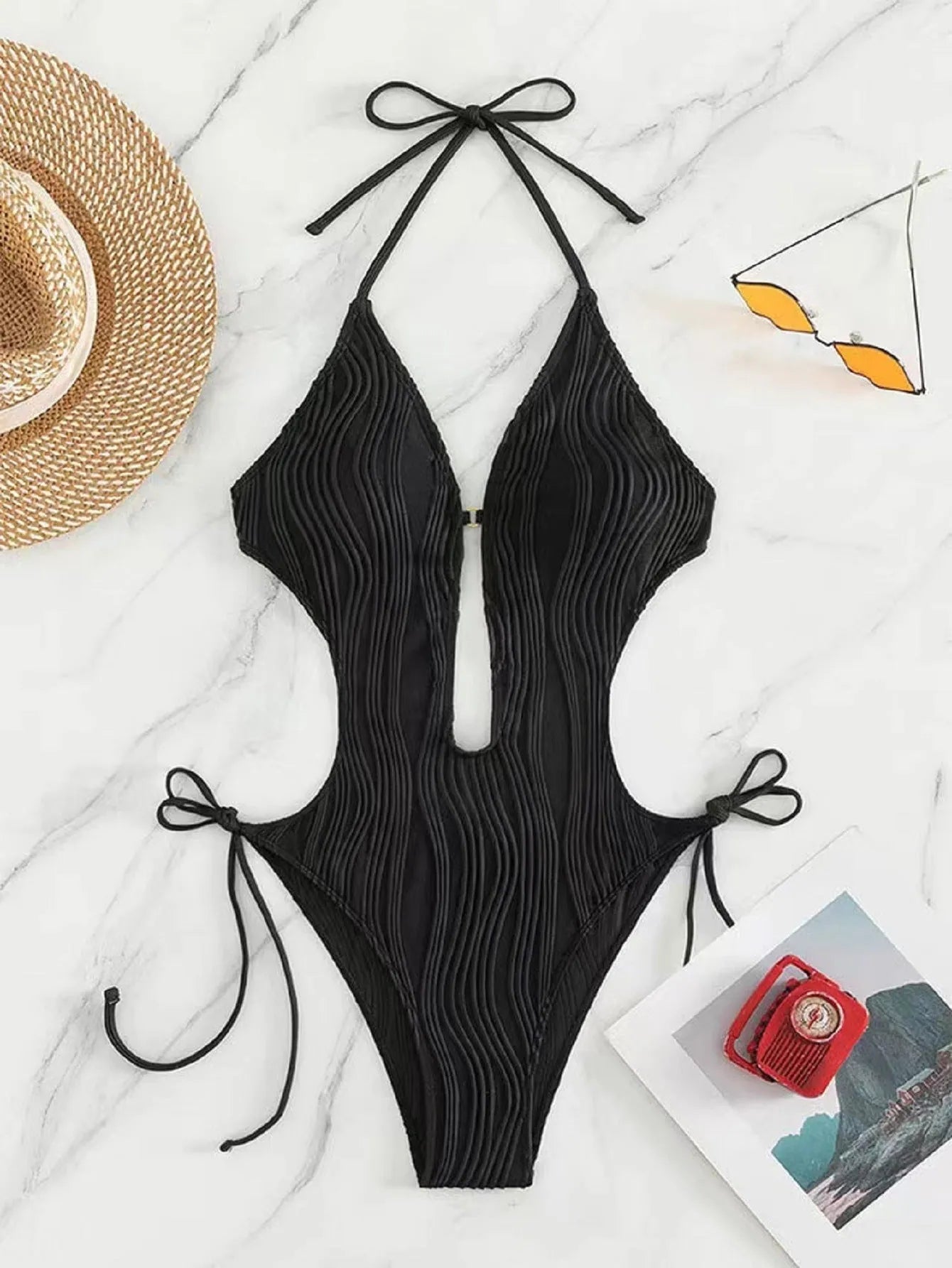 Women's black lace up triangle bikini swimsuit on solid colour background