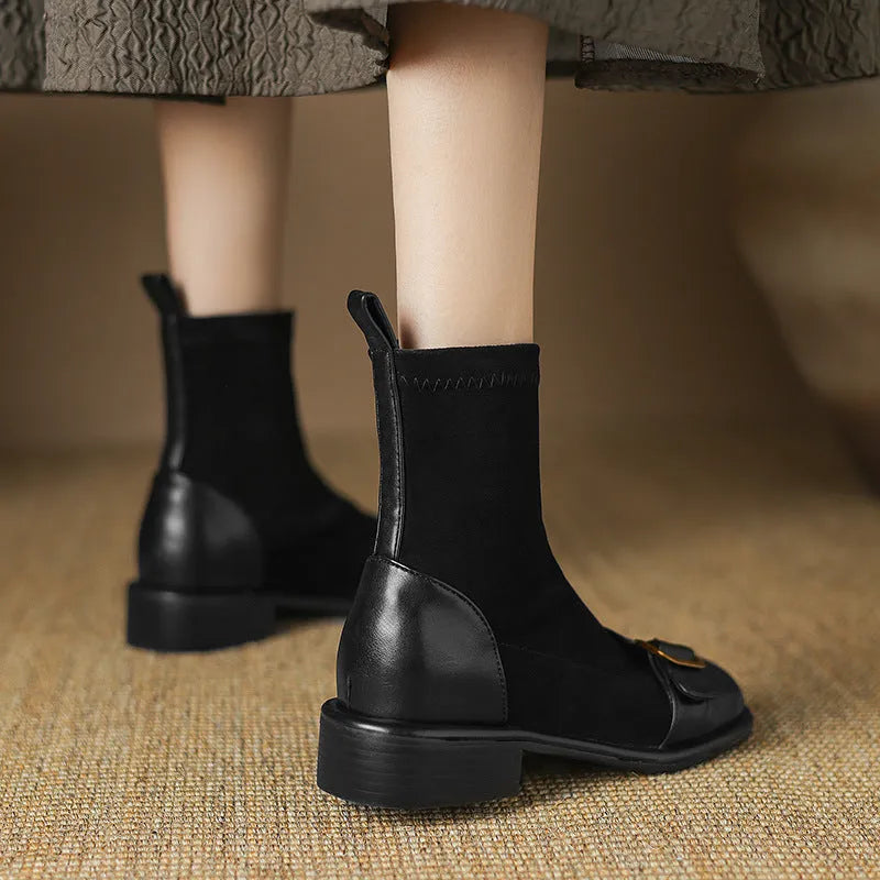 Women's black low heel Martin boots with front lace-up and belt buckle stitch detailing on a white background.