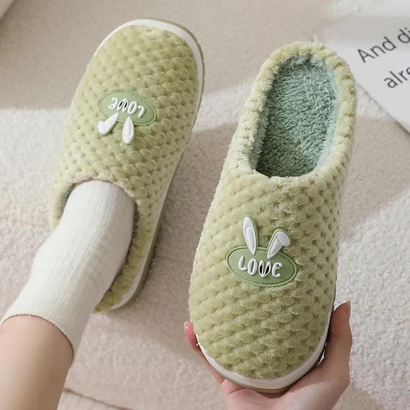 Women's rabbit plaid design artificial fur house slippers with a thick rubber sole.