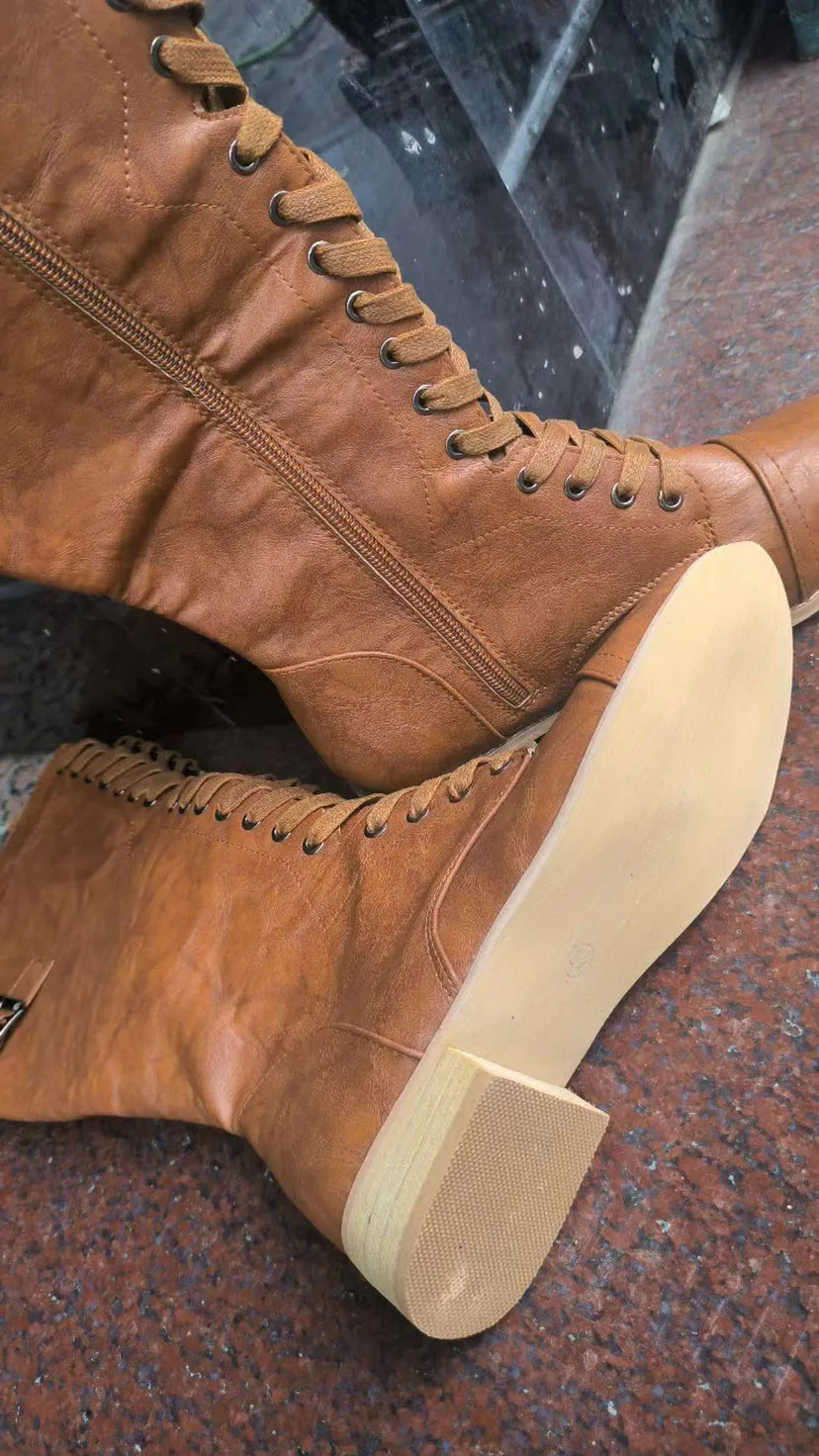 Women's black knight-style ankle boots with a cross-strap fastening across the front.