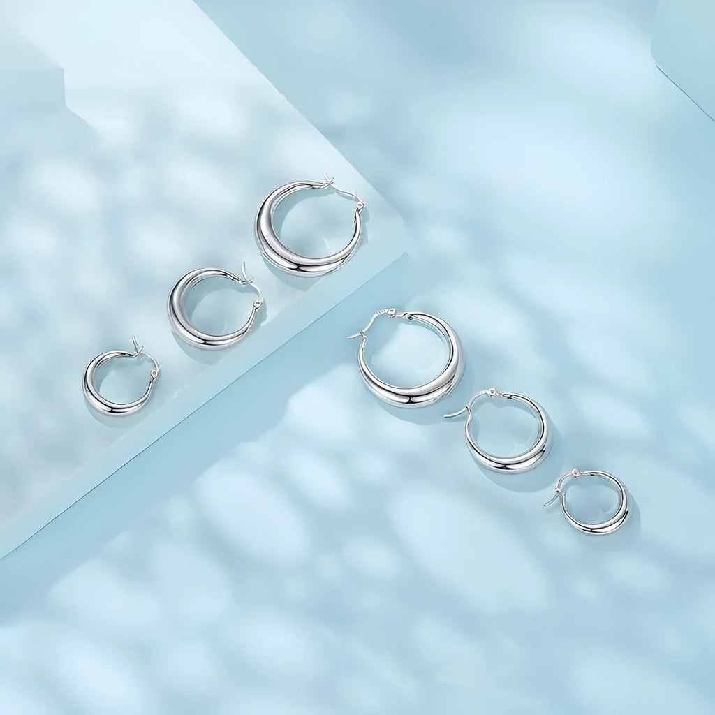 Copper ring ear clip earrings with a silver needle, shown in classic geometry design.