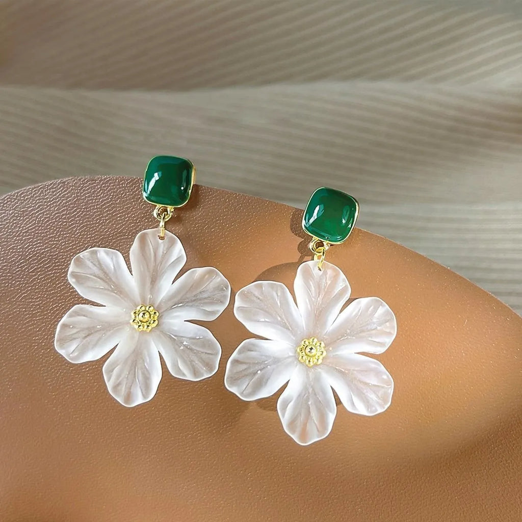 A pair of dark green and alloy needle flowers design drop earrings for women.
