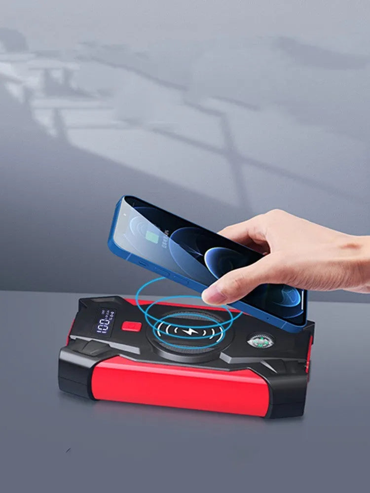 Red portable car emergency jump starter with digital display and thick clamps for 12V vehicle battery rescue