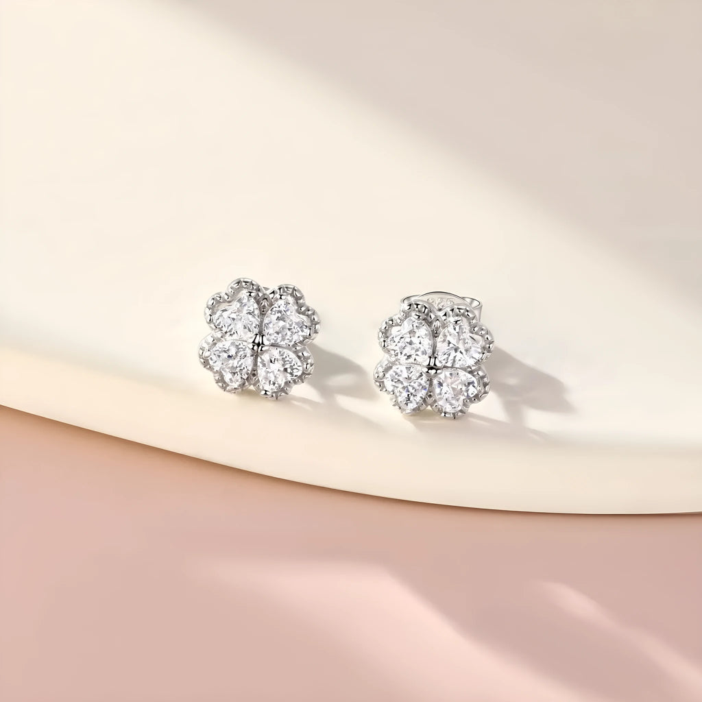 Pair of 925 silver heart-shaped earrings with inlaid zircon stones and a white gold colour finish.