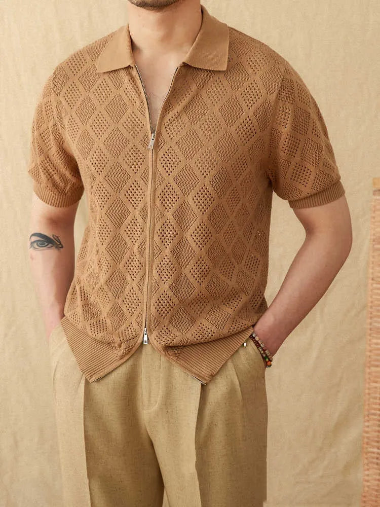 Man's light brown cotton cardigan with a front zipper, lapel collar, and short sleeves laid flat.