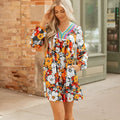 Orange floral print mini dress with striped lace detailing, V-neck, and long sleeves.