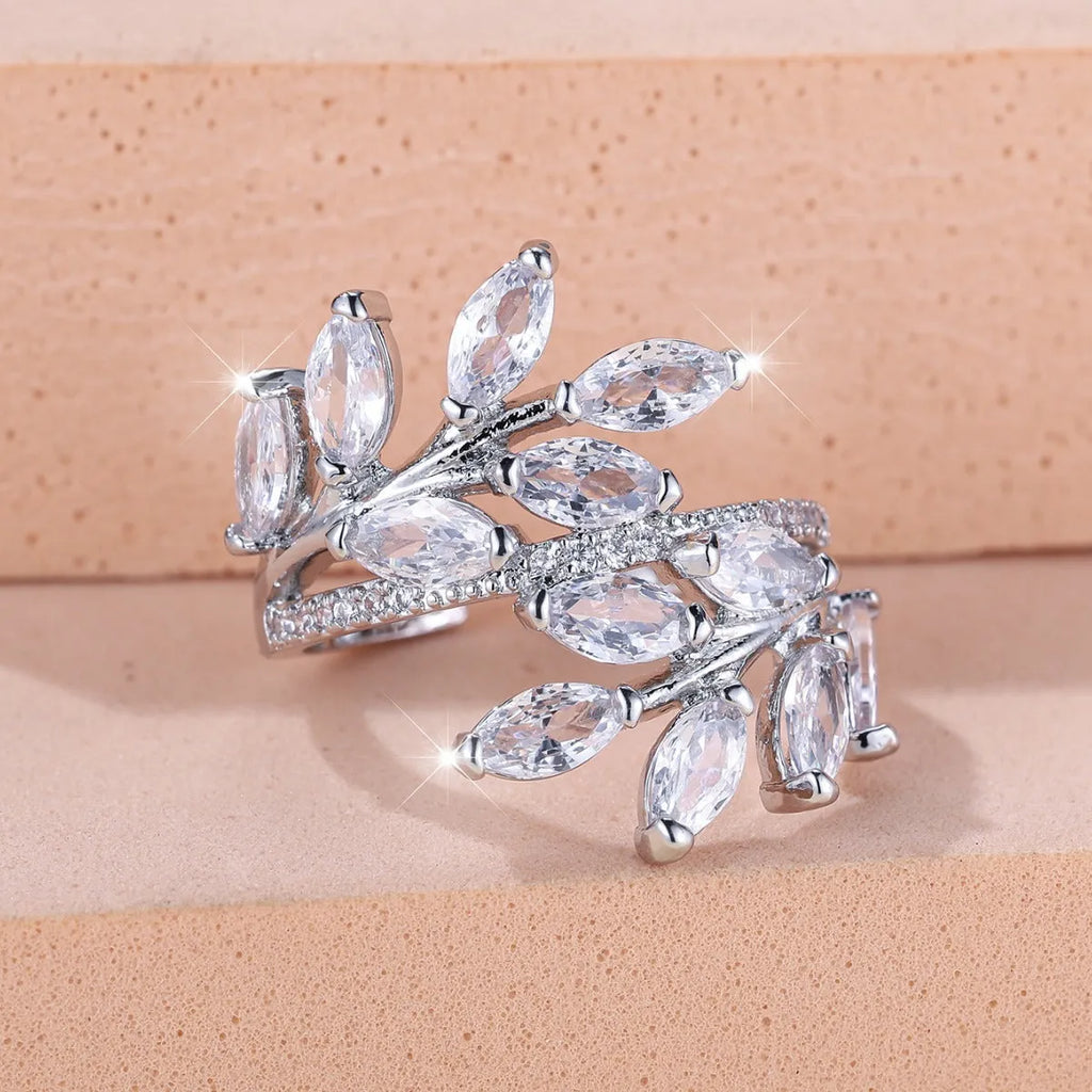Adjustable opening copper leaf fashion ring with sparkling zirconia stones in a rose gold finish.