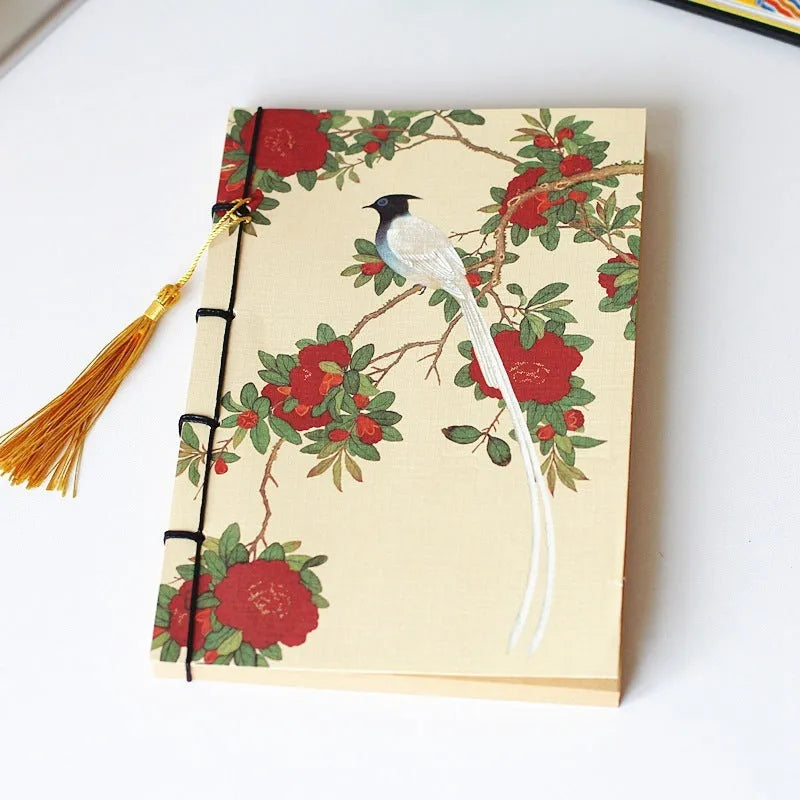 A5 antique wire-bound notebook with retro painting cover, thread binding, and black tassels.