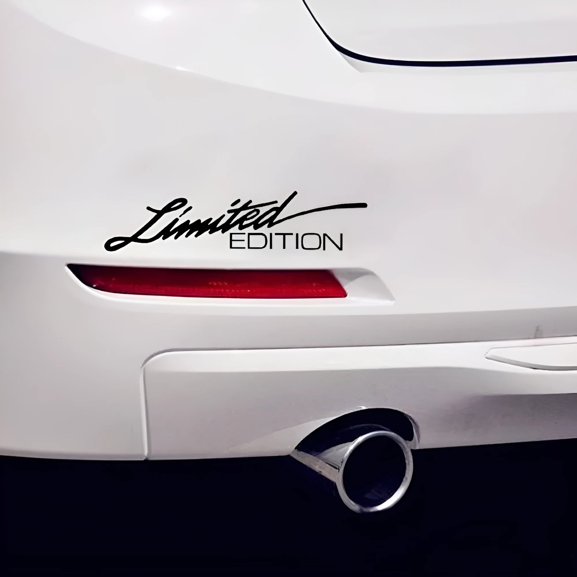Close-up of a reflective plastic bumper sticker showing British style text, measuring 16cm long.