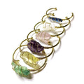 Unisex rough natural crystal bracelet with geometric gold metal winding on a wrist