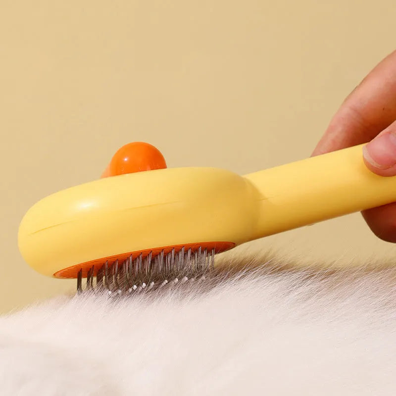 Small yellow duck-shaped pet grooming comb with stainless steel needles
