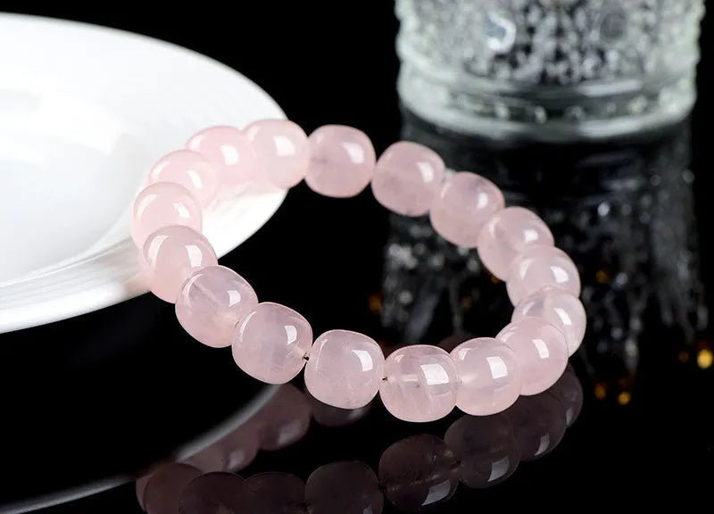 Pink crystal barrel bead bracelet with bamboo accents and geometric design