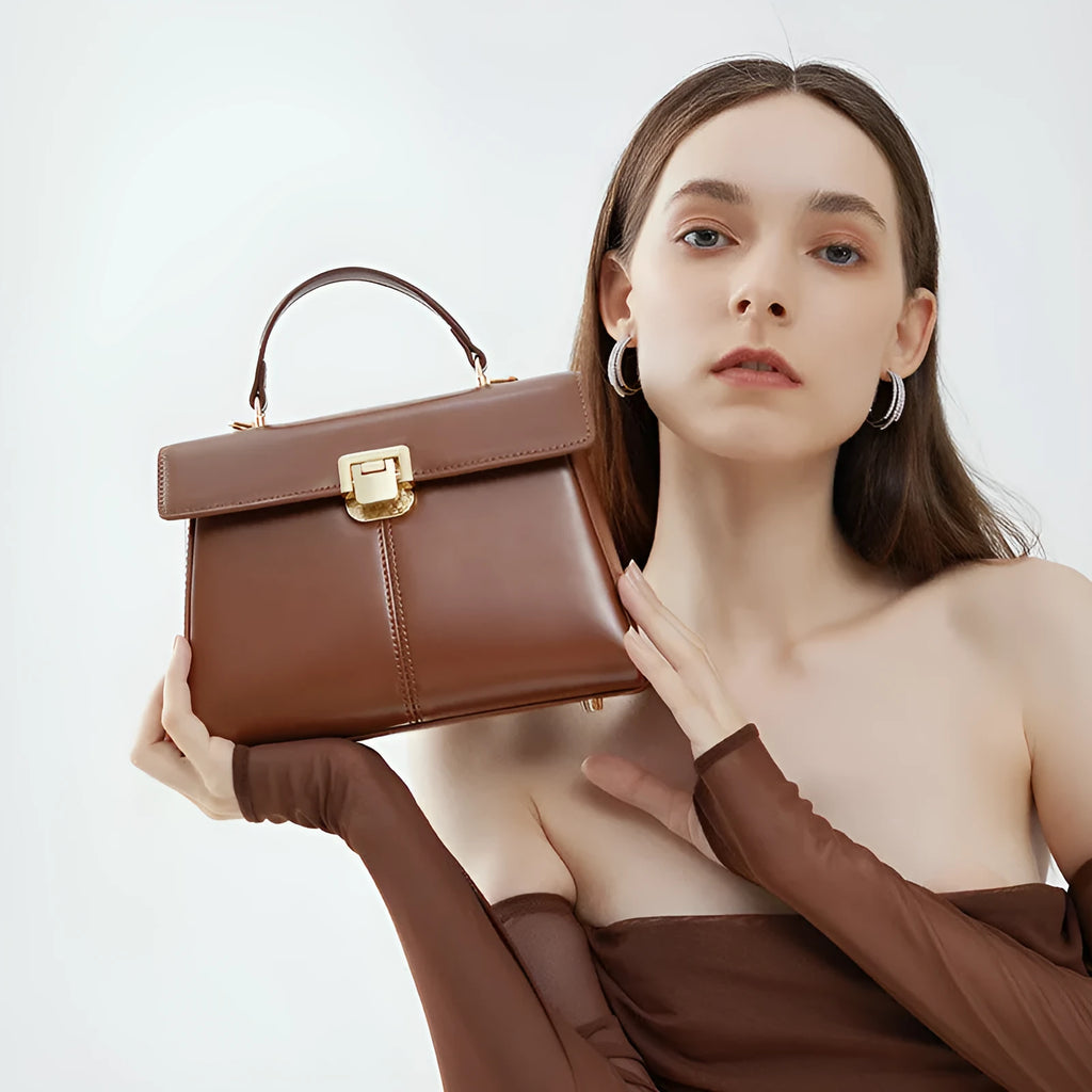 Black genuine leather shoulder bag with clasp closure showing internal compartments and adjustable strap
