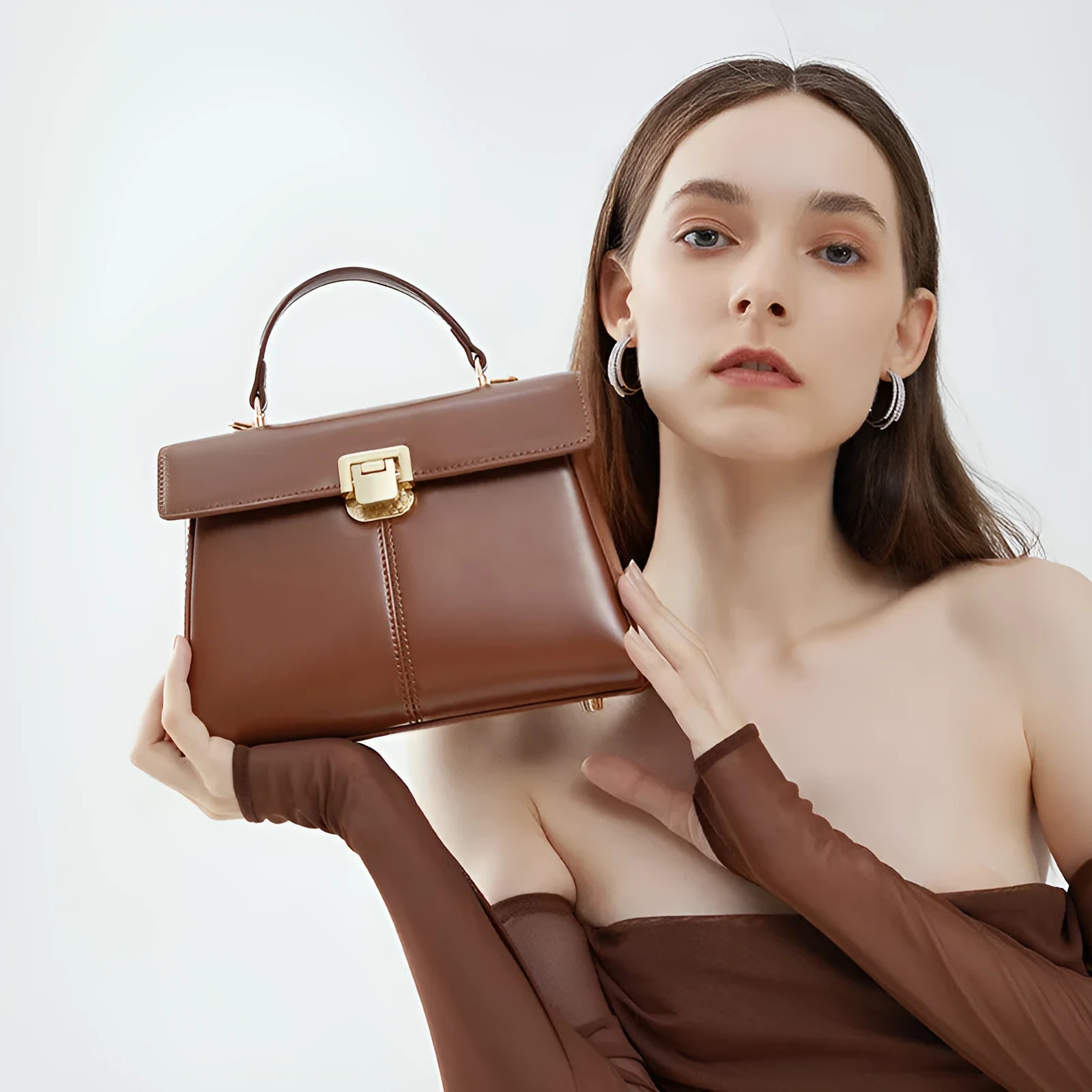 Black genuine leather shoulder bag with clasp closure showing internal compartments and adjustable strap