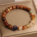 Women's crystal bracelet with yellow tower crystal and ebony amethyst beads featuring pearl and rhinestone accents
