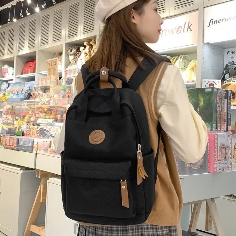 Black Oxford cloth leisure backpack with curved shoulder straps and retro sewing thread detailing