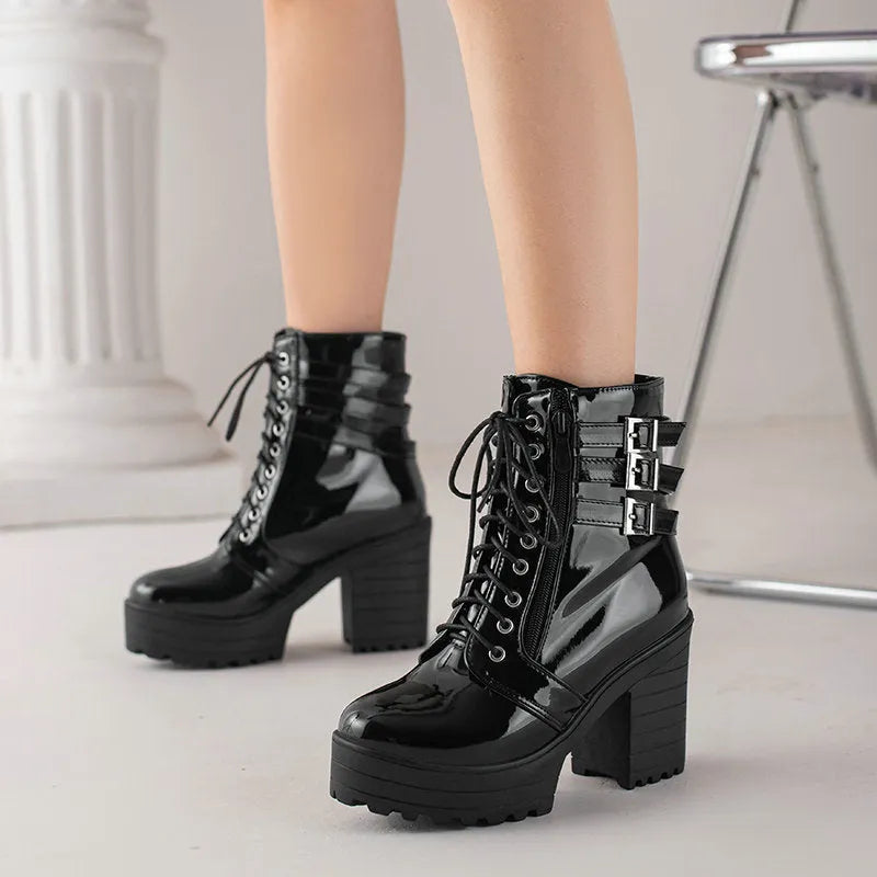Women's black chunky heel ankle boots with front lace-up and round toe on a waterproof rubber sole.